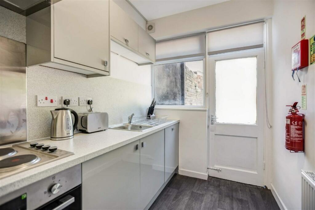 Bright modern galley kitchen with appliances...