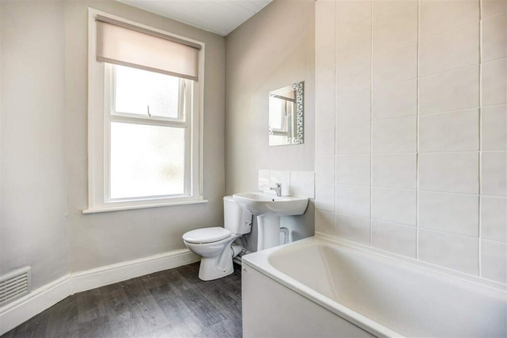 Bright modern bathroom with bath and basin...