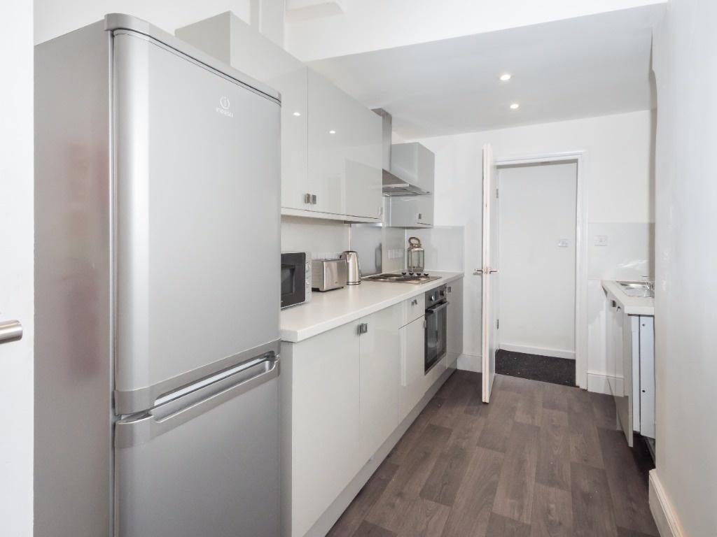 Modern galley kitchen with integrated appliance...