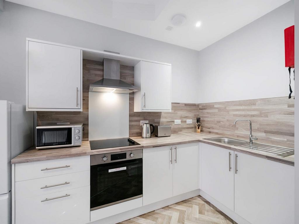 Modern fitted kitchen with integrated appliance...
