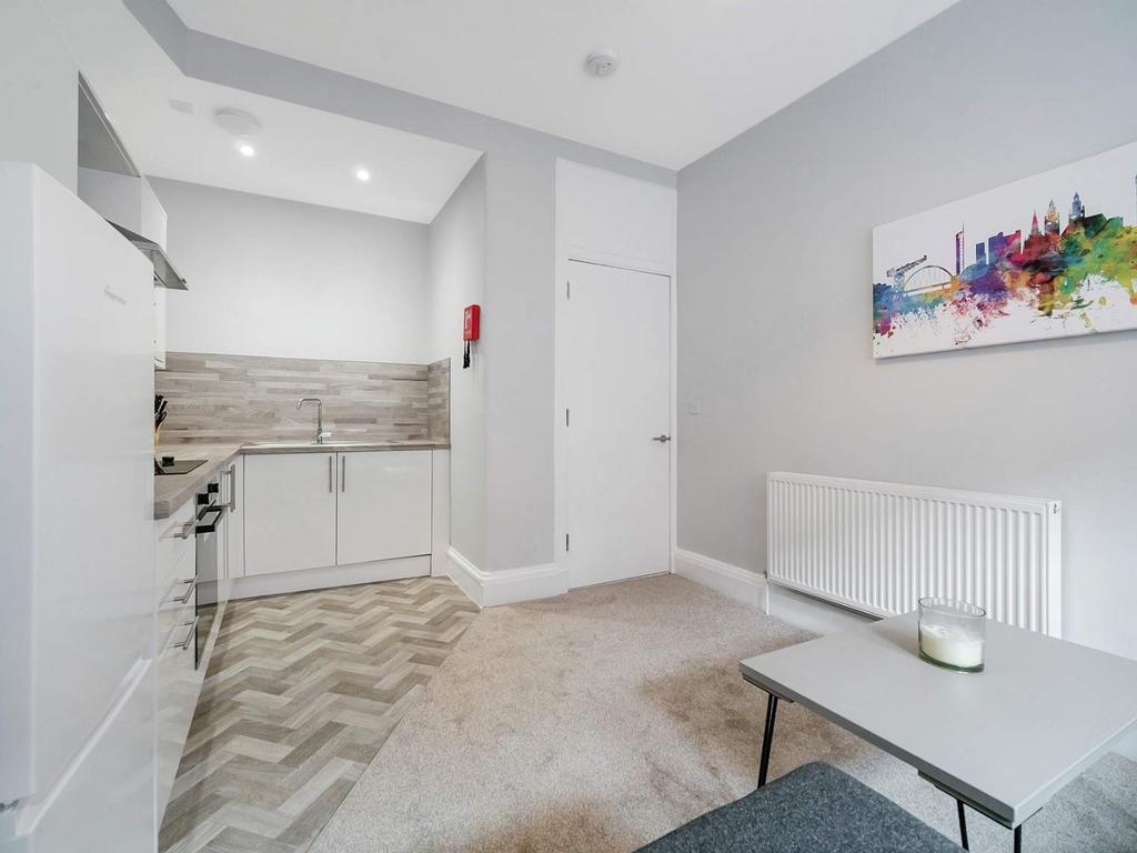 Bright studio-style living area with kitchenett...