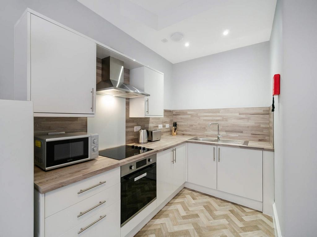 Modern fitted kitchen with integrated appliance...