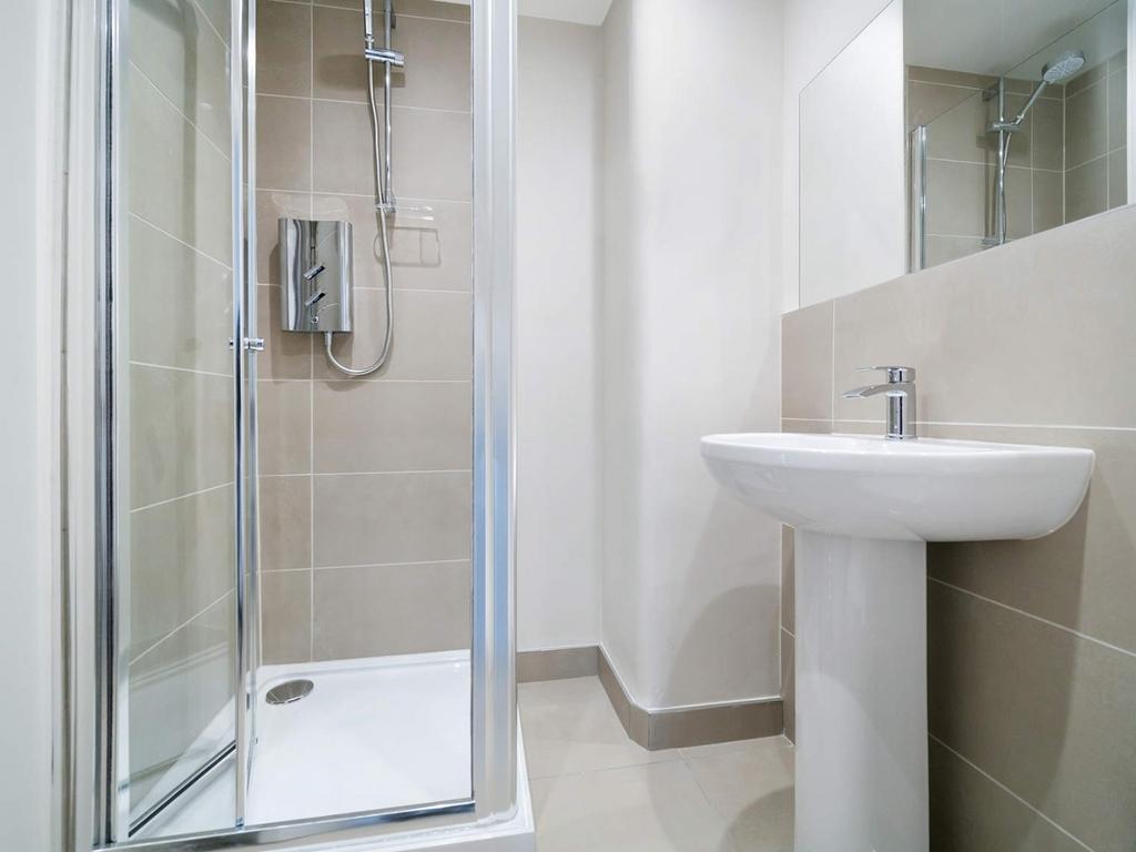 Clean modern bathroom with shower and basin...