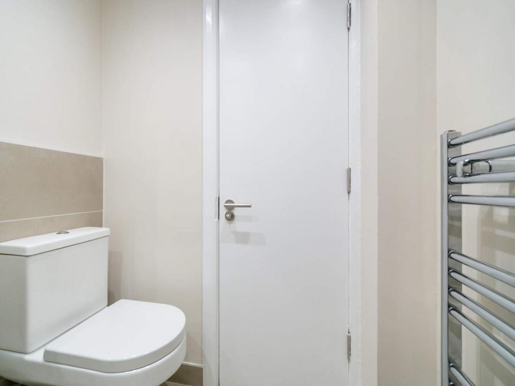 Clean modern WC with heated towel rail...