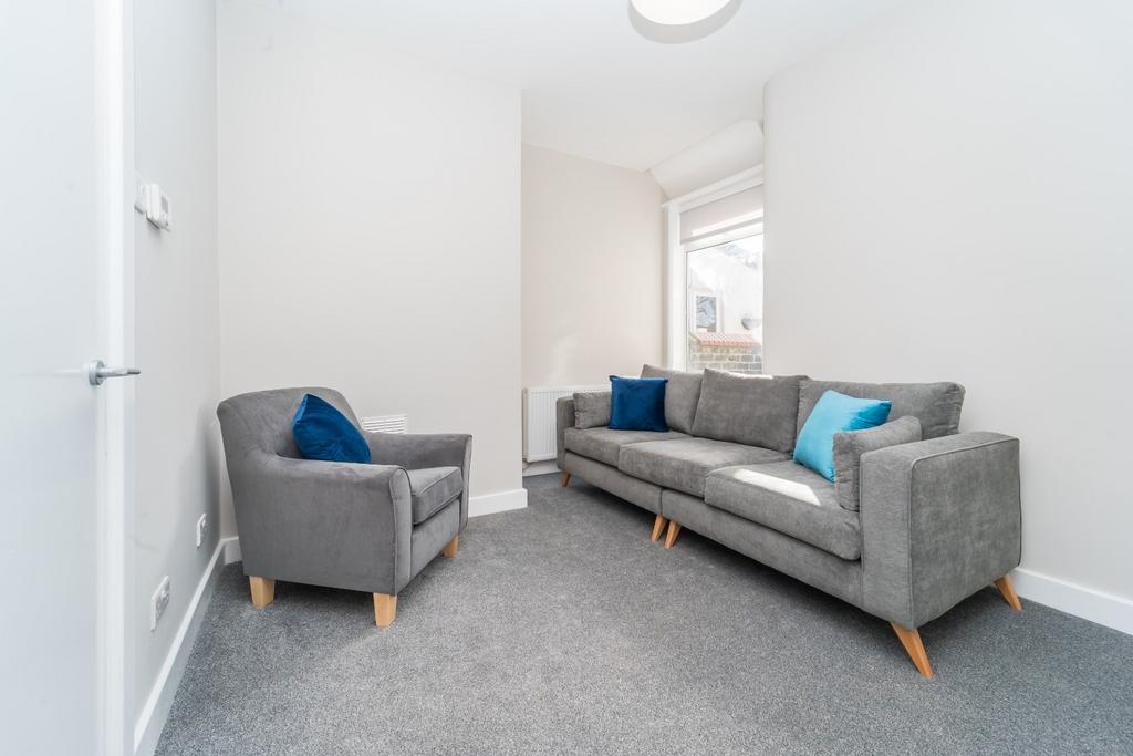 Bright, modern lounge with sofa and armchair...
