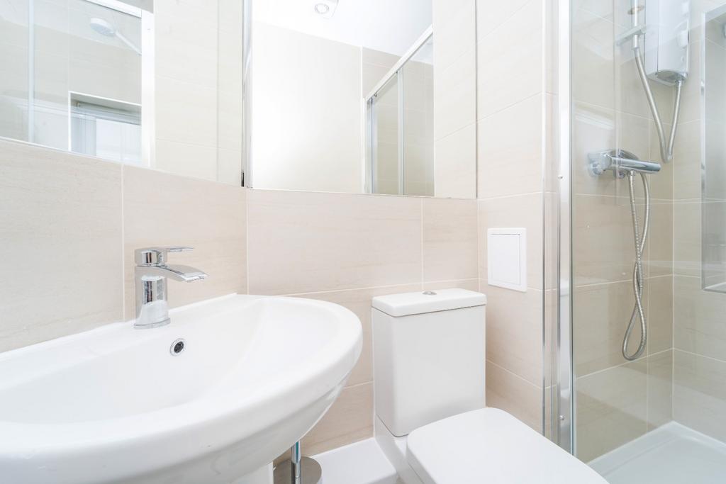 Bright modern bathroom with shower and basin...