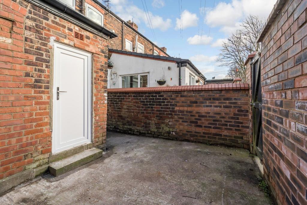 Private walled courtyard with brick features...
