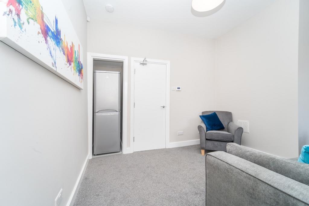 Bright communal lounge with seating and neutral...
