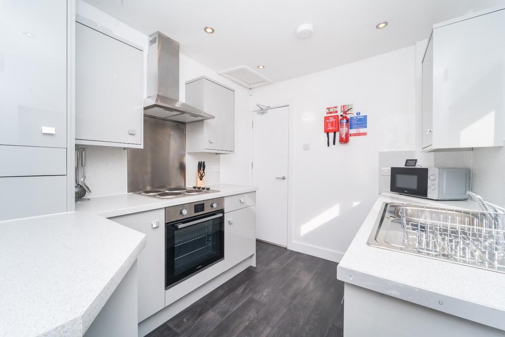 Bright modern kitchen with white units...