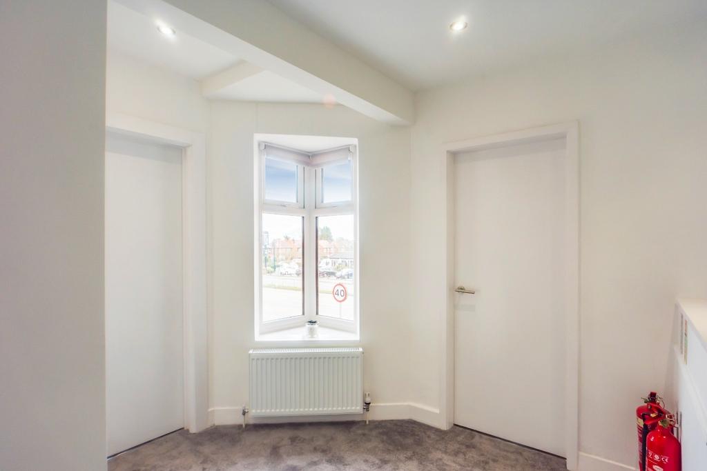 Bright, clean hallway with bay window and radia...