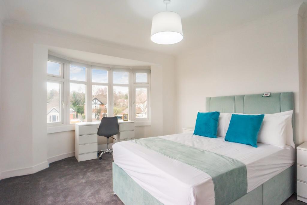 Bright bedroom with bay window and desk...