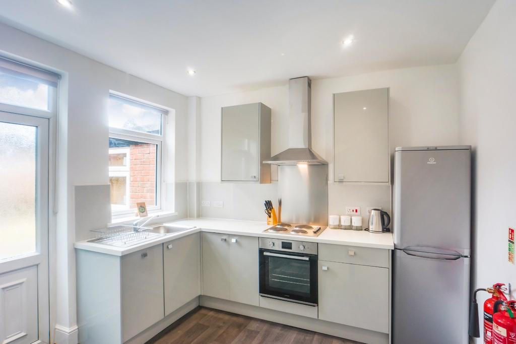 Bright modern kitchen with integrated appliance...
