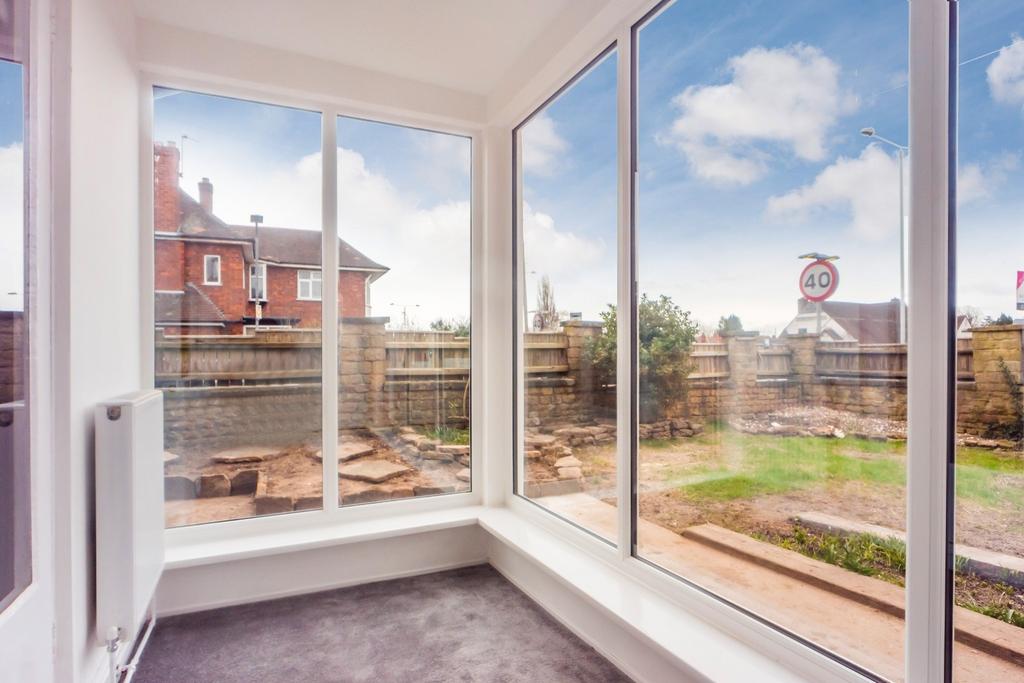 Bright sunroom with large windows and garden vi...