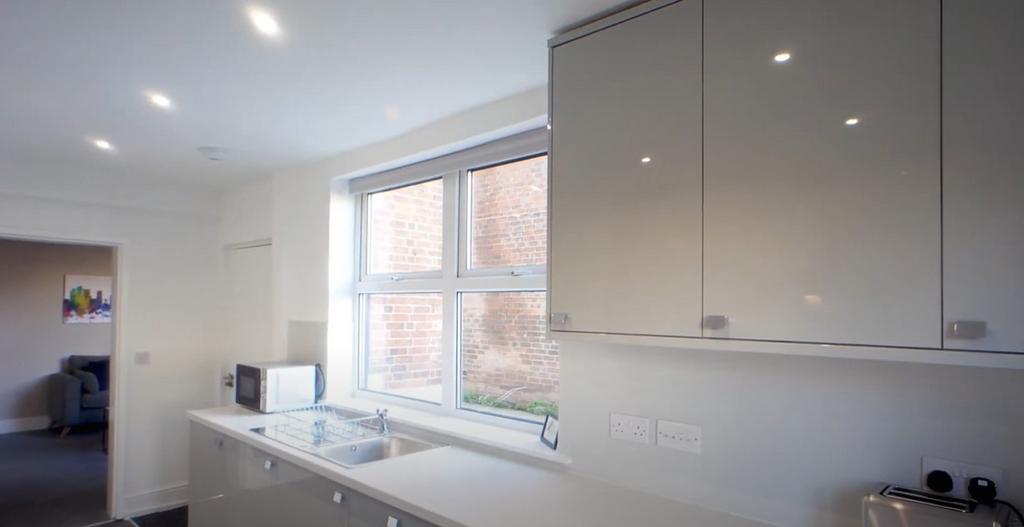 Bright modern kitchen with glossy cabinets...
