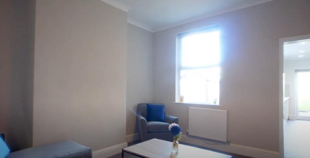 Bright bedroom with large window and neutral de...