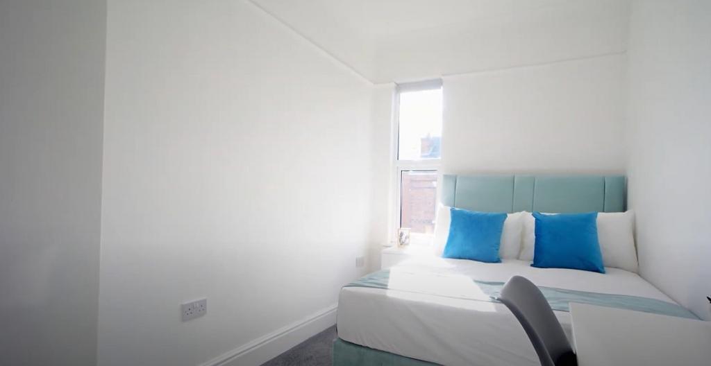 Bright, clean bedroom with modern bedding...