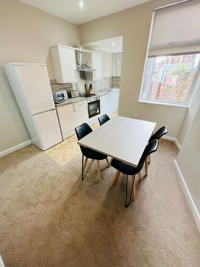 Bright modern kitchen with dining table...