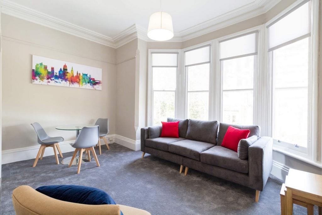 Bright bay-window living room with dining area...