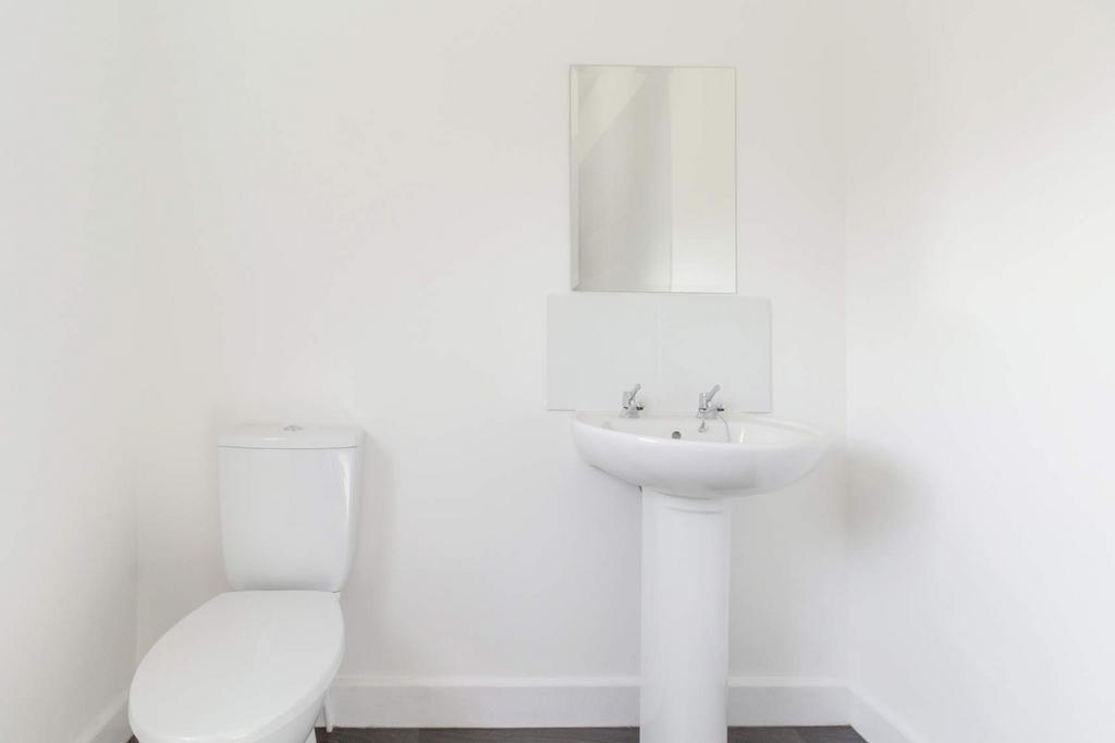 Bright minimalist bathroom with basin and WC...