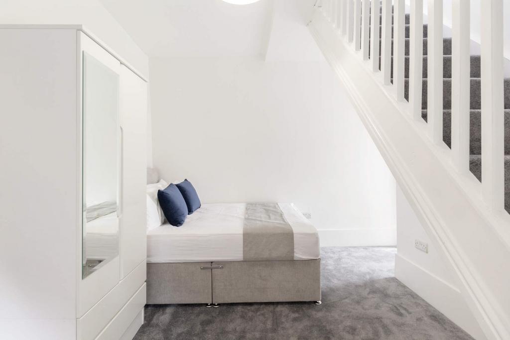 Bright, neat bedroom with neutral décor...