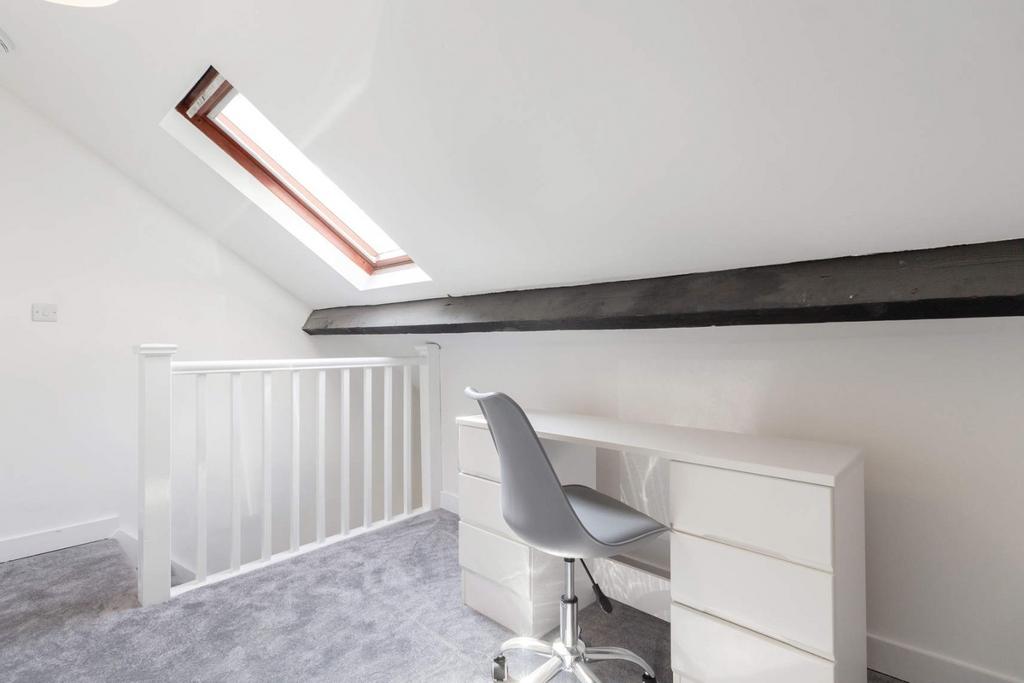 Bright loft workspace with desk and skylight...