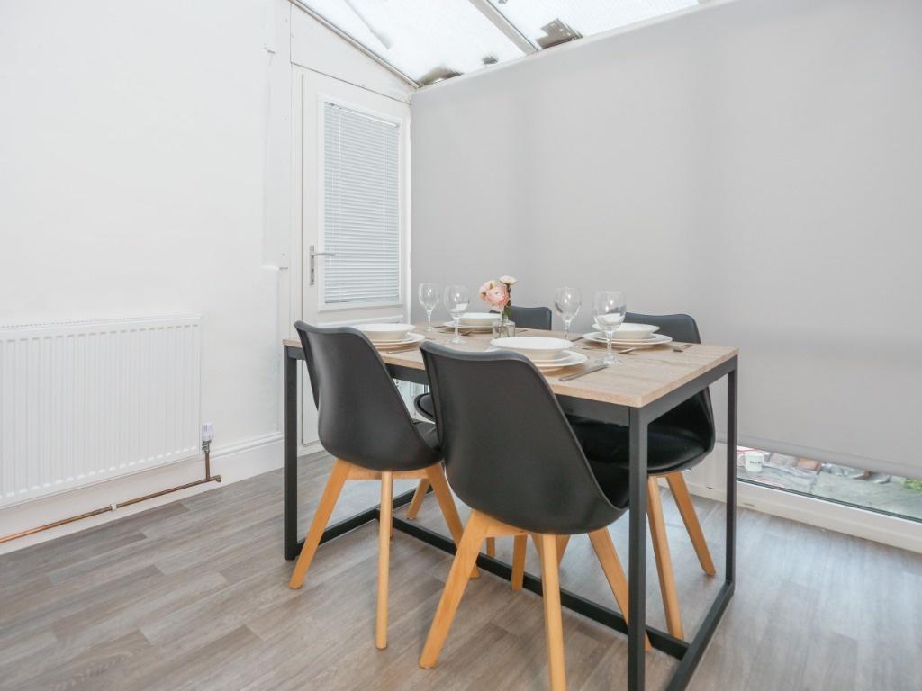 Bright dining nook with modern table and chairs...