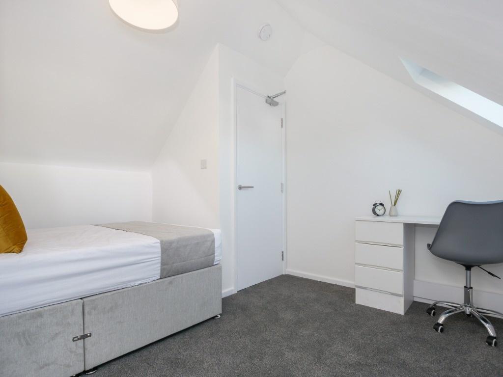 Bright attic room with bed and study area...