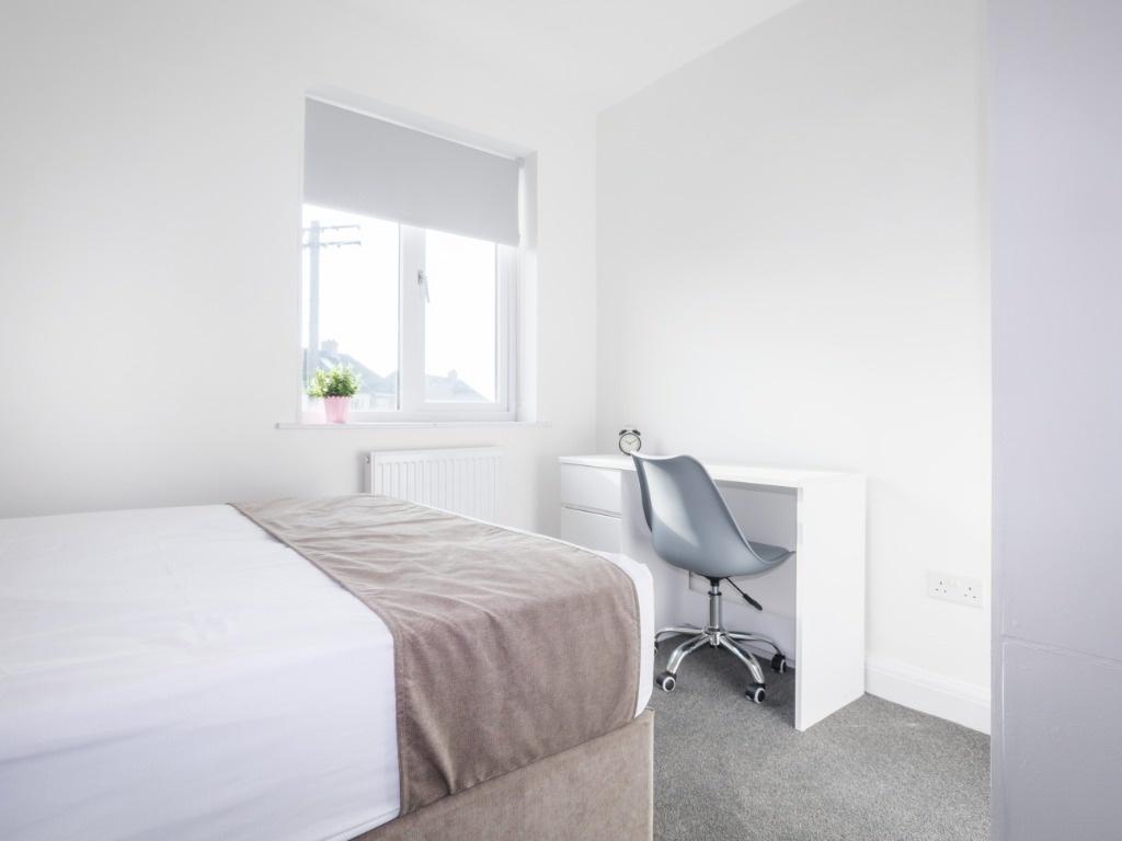 Bright, minimal double bedroom with desk and vi...