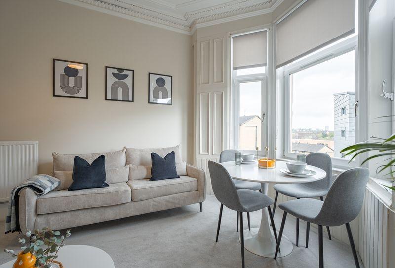 Bright, stylish living room with bay window...
