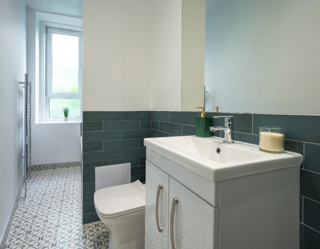 Bright modern bathroom with vanity and fresh ti...