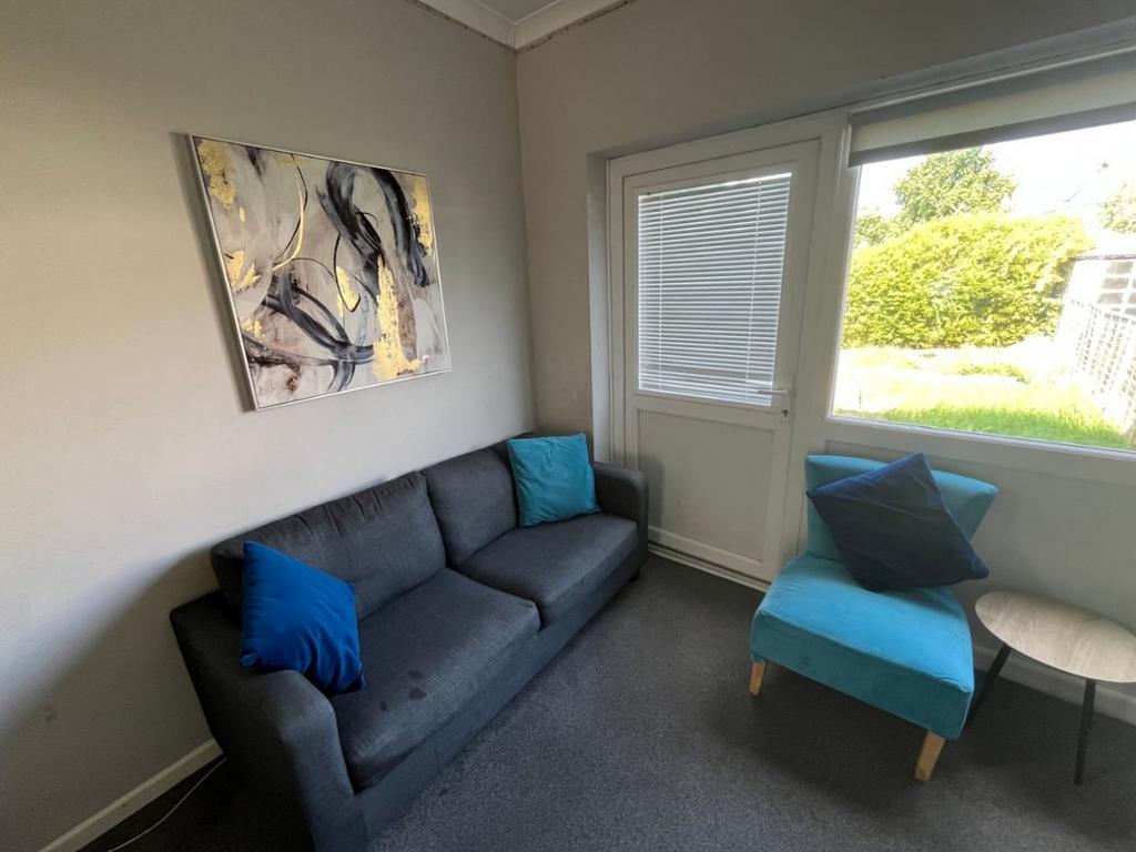 Bright lounge with sofa and garden view...