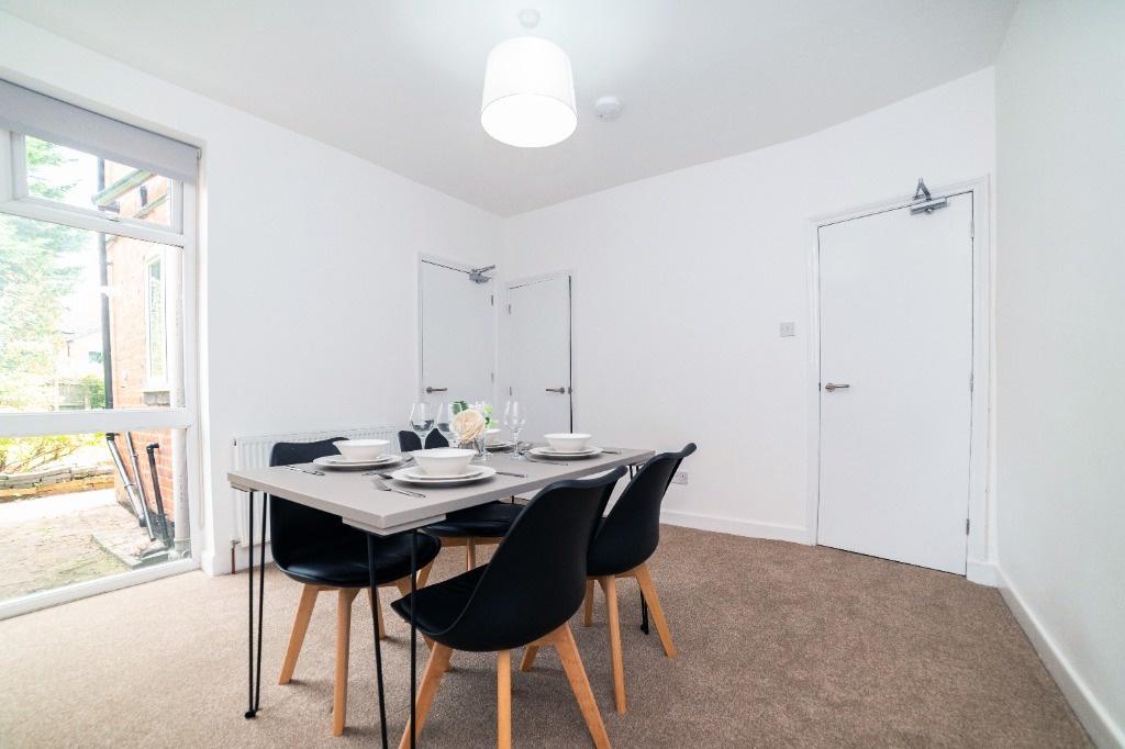 Bright, neutral lounge with dining area...