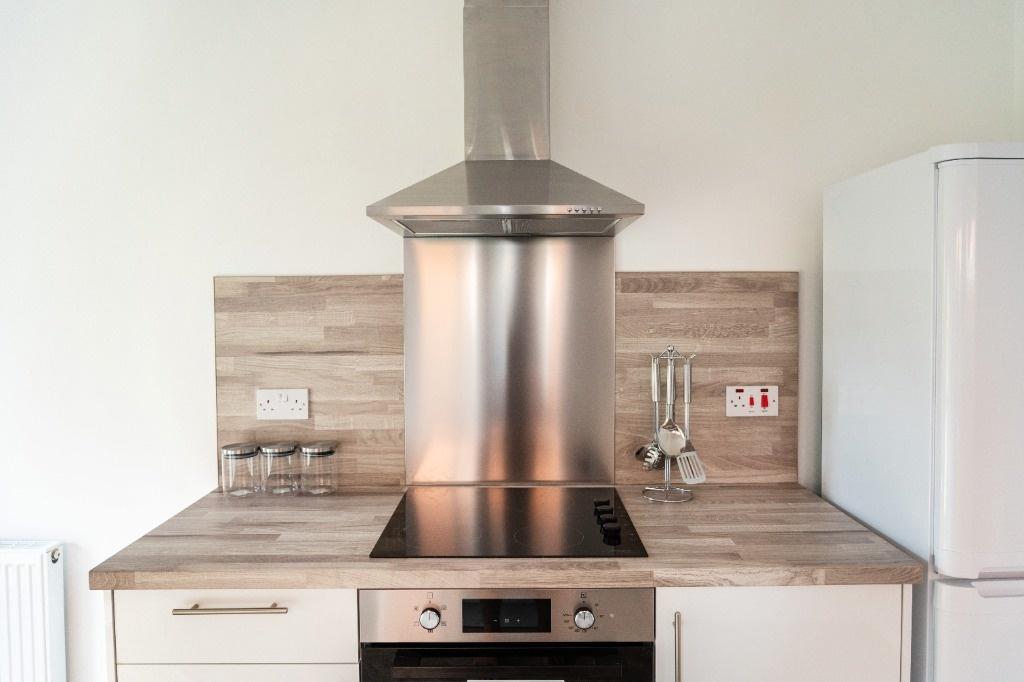 Modern compact kitchen with stainless appliance...