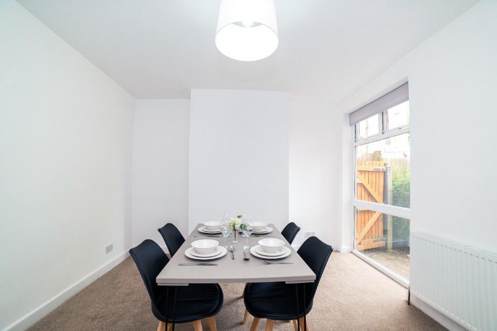 Bright dining space with modern table and chair...