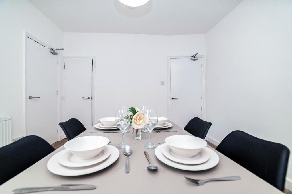 Bright modern dining area with table set...