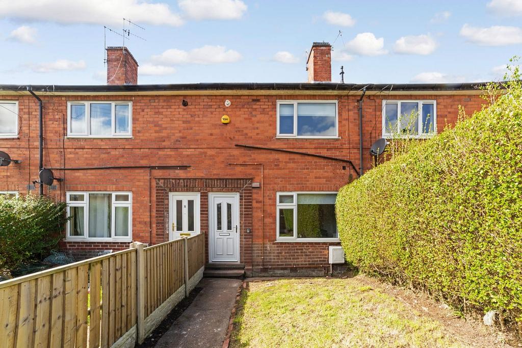 Well-kept terraced house with neat front garden...