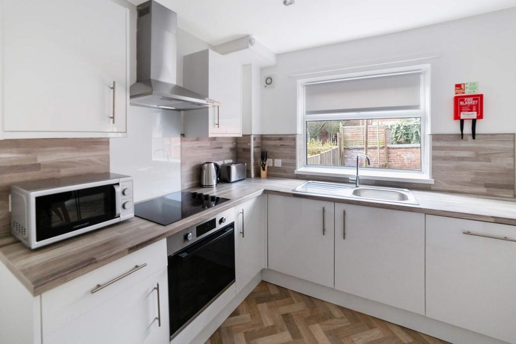 Bright modern kitchen with integrated appliance...