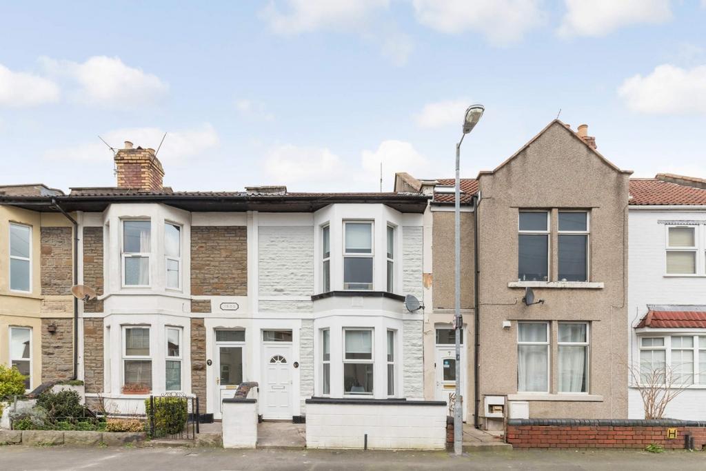 Terraced house with bay windows and curbside vi...