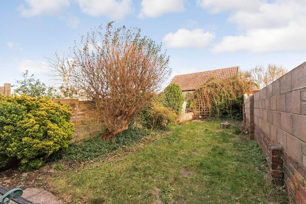 Enclosed rear garden with lawn and shrub border...