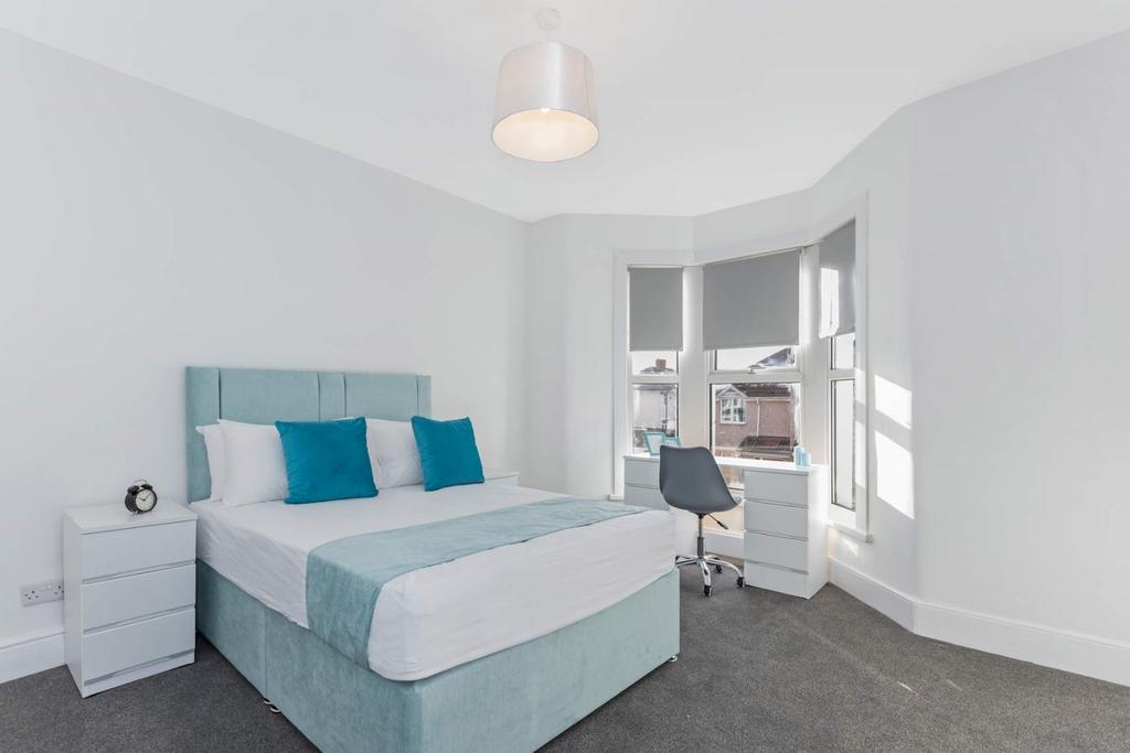 Bright bedroom with bed and study area...