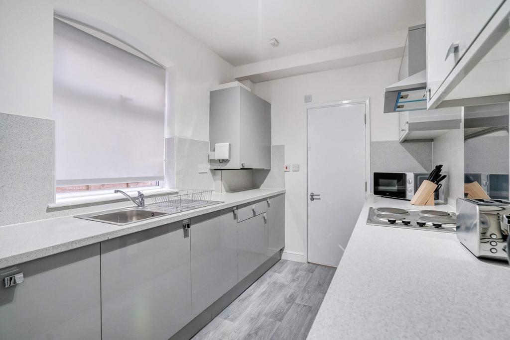 Bright modern galley kitchen with appliances...