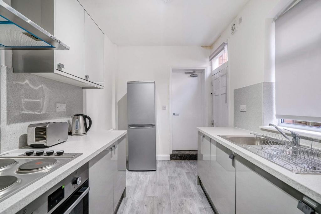 Bright modern galley kitchen with ample storage...