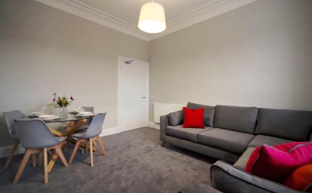 Bright living room with sofa and dining area...