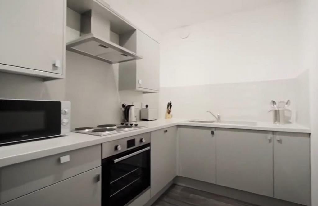 Modern fitted kitchen with white cabinets...