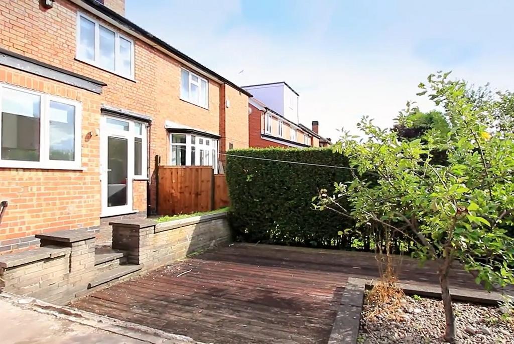 Private paved rear garden with seating area...