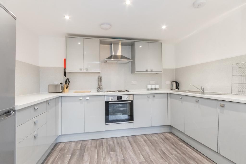 Modern fitted kitchen with integrated appliance...