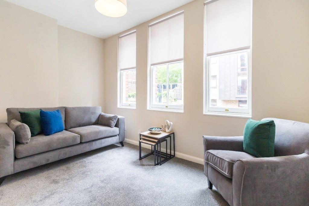Bright, neutral living room with comfy seating...