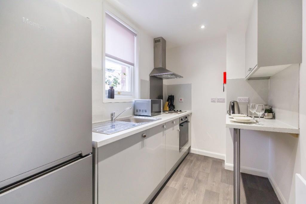 Bright modern galley kitchen with appliances...