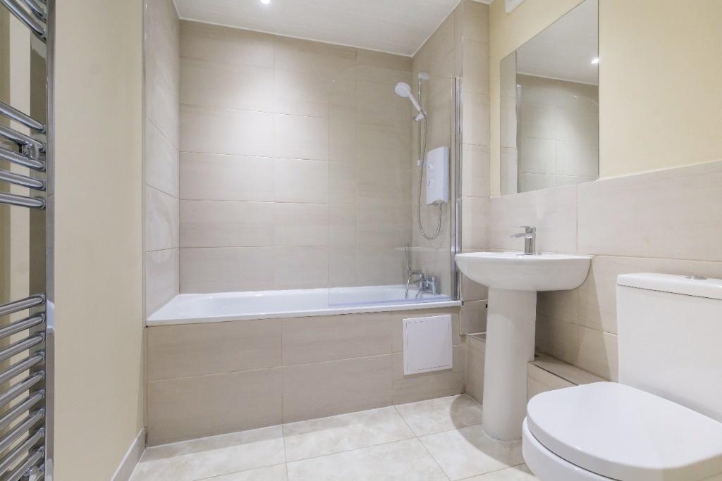 Bright modern bathroom with bath and clean fini...