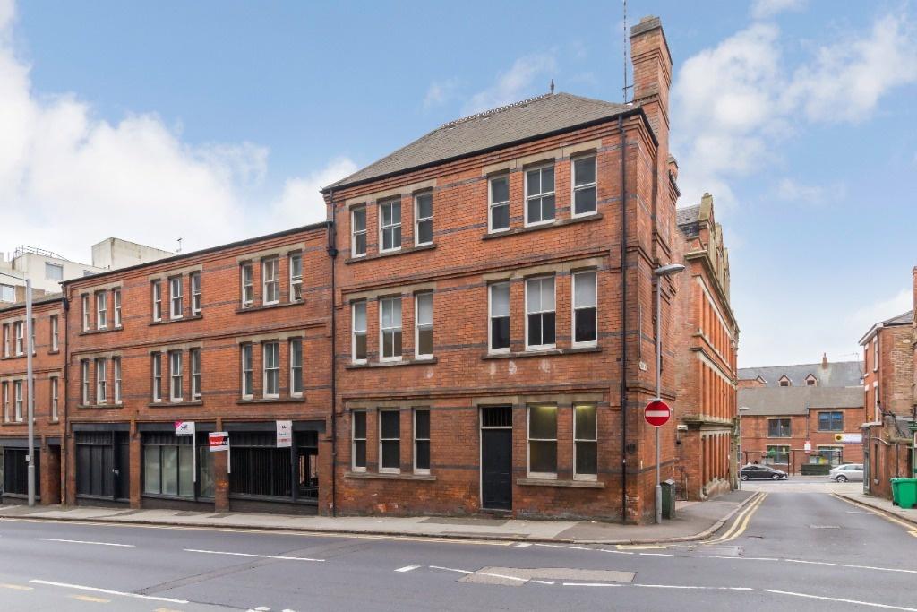 Attractive red-brick corner building on a brigh...